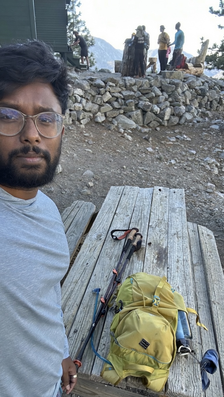 Resting at the ski hut with poles and pack on the picnic table